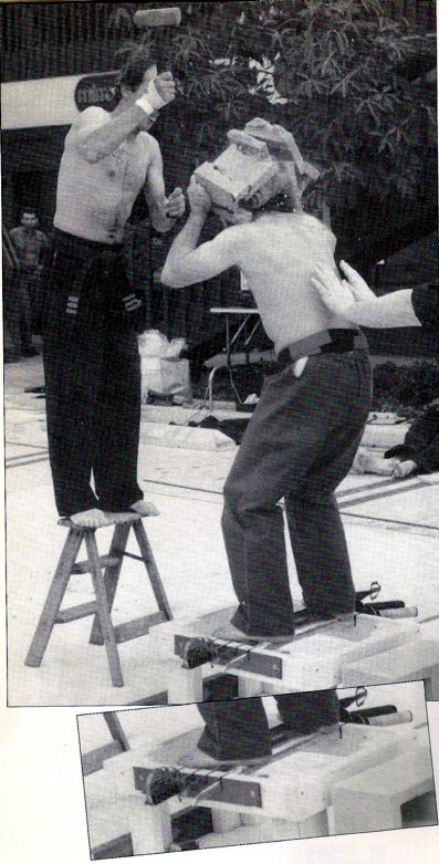 Olivier standing on sharp swords while cement blocks are broken over his head.