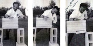 Olivier standing over a stack of 6 cement blocks. He is preparing to break only the last one on the stack.