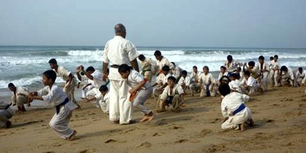 Practicing martial arts barefoot on the sand