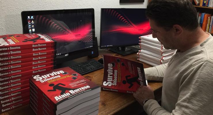 Alain Burrese signing his Survive a Shooting Books