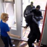 Woman experiencing a home invasion