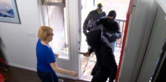 Woman experiencing a home invasion