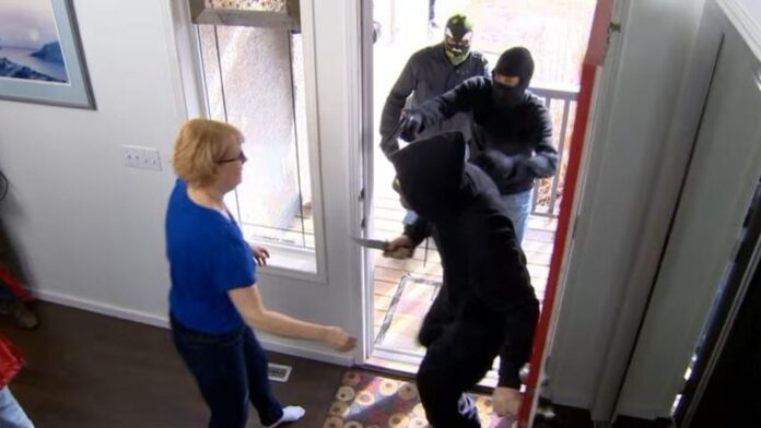 Woman experiencing a home invasion